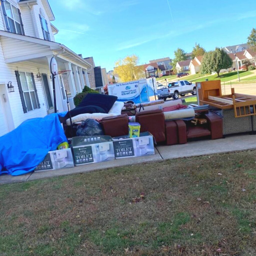 A customer's driveway piled high with unwanted junk furniture
