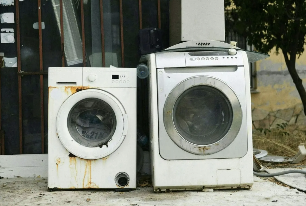 Old washing machine and dryer ready for scrapping and recycling